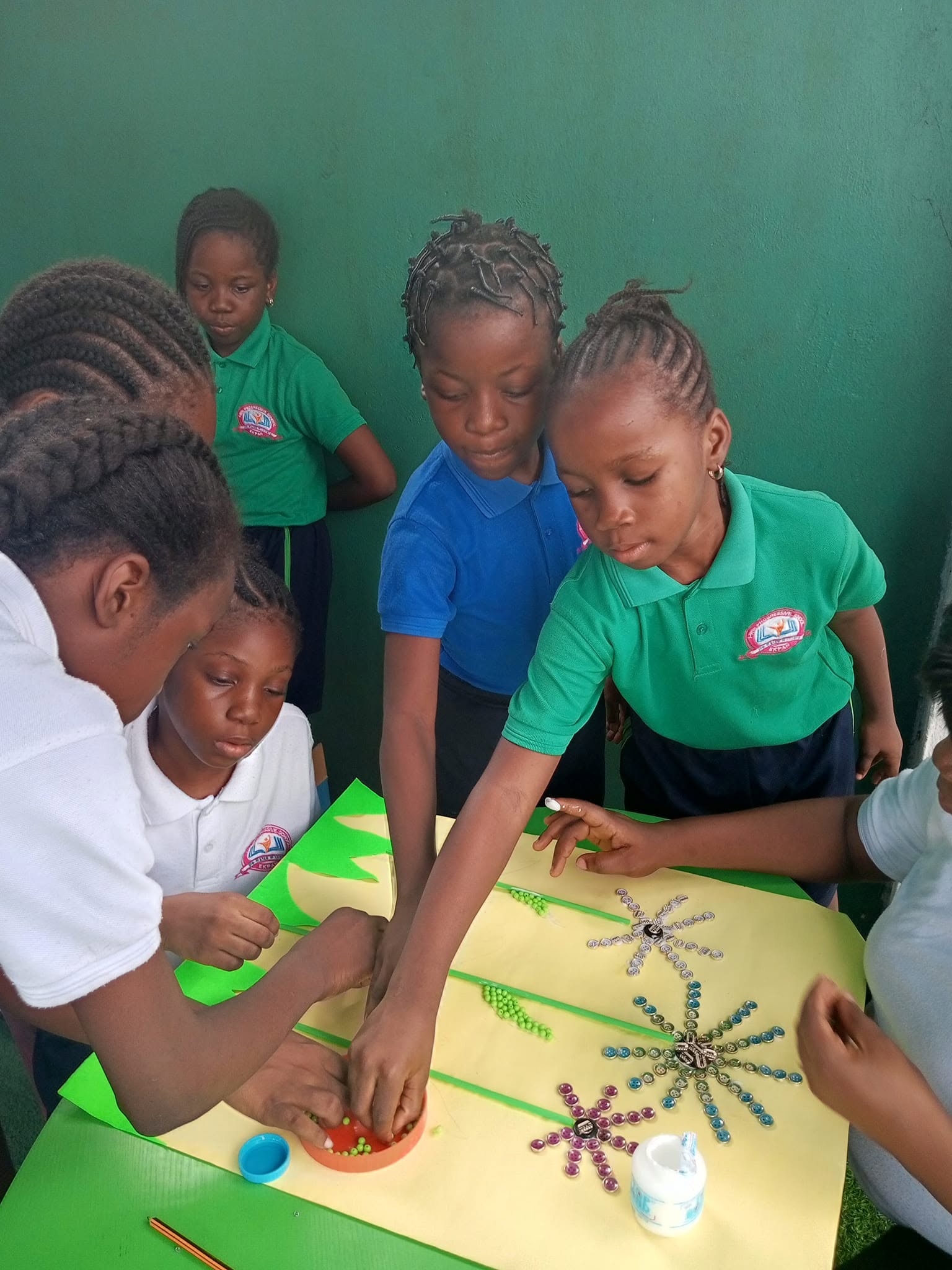 Teacher guiding pupils during a craft activity
