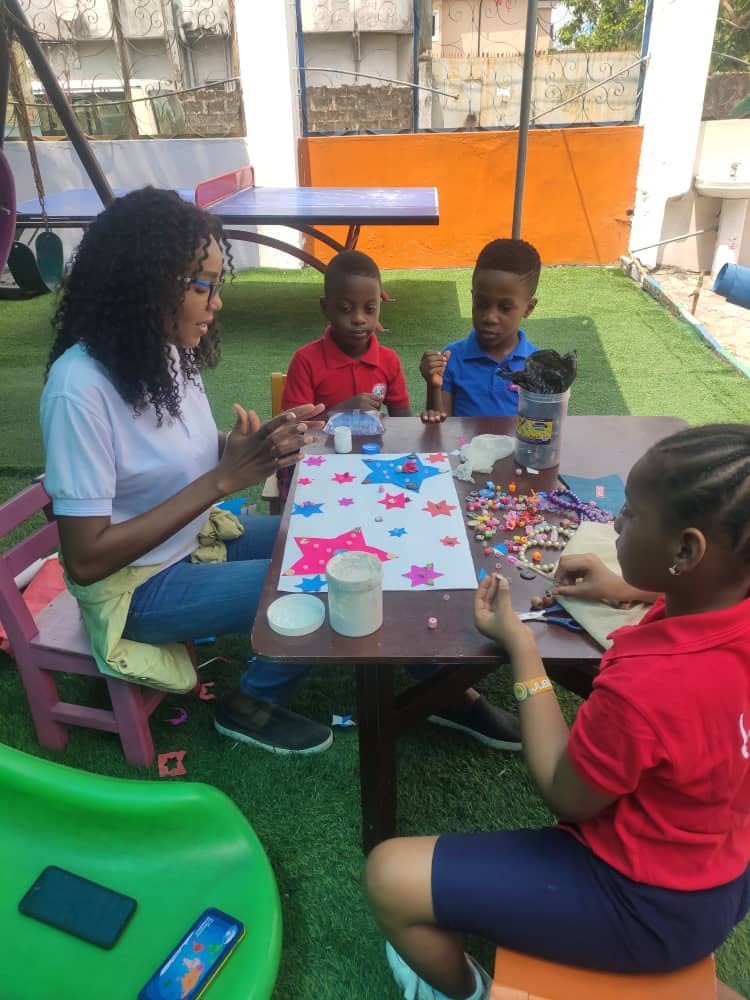 Children presenting group craft work